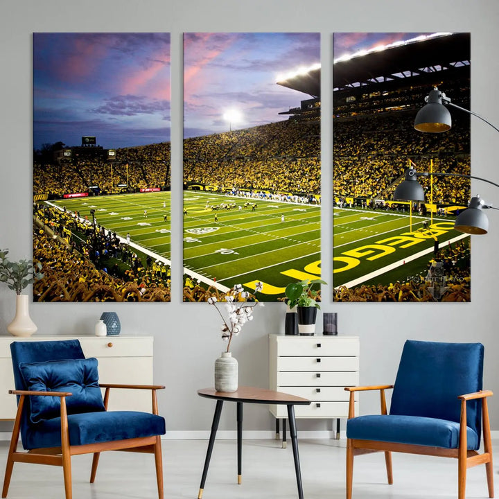 The living room showcases a triptych titled "University of Oregon Ducks Football Team Print - Eugene Autzen Stadium Wall Art Canvas Print," exhibiting a football stadium at sunset with a premium gallery-quality finish.