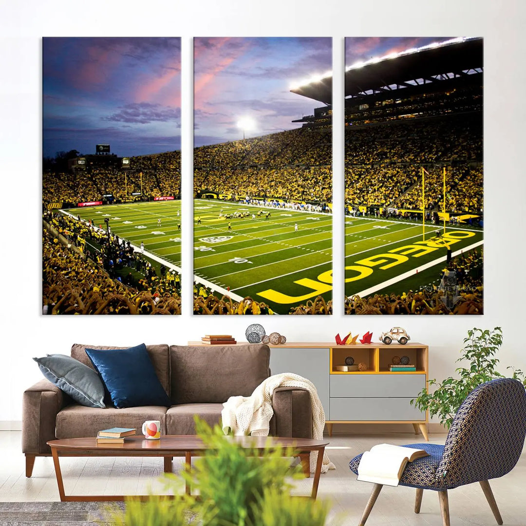 The living room showcases a triptych titled "University of Oregon Ducks Football Team Print - Eugene Autzen Stadium Wall Art Canvas Print," exhibiting a football stadium at sunset with a premium gallery-quality finish.