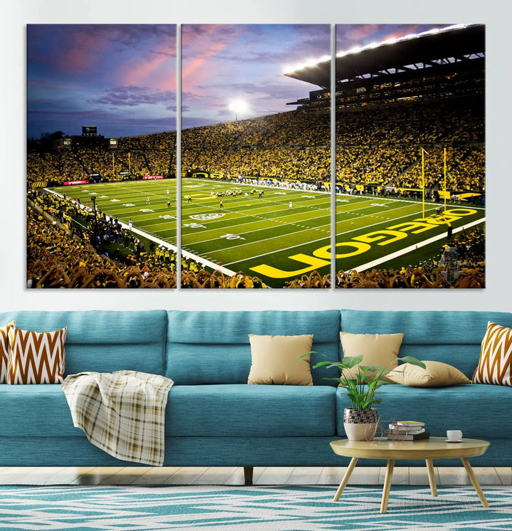 The living room showcases a triptych titled "University of Oregon Ducks Football Team Print - Eugene Autzen Stadium Wall Art Canvas Print," exhibiting a football stadium at sunset with a premium gallery-quality finish.