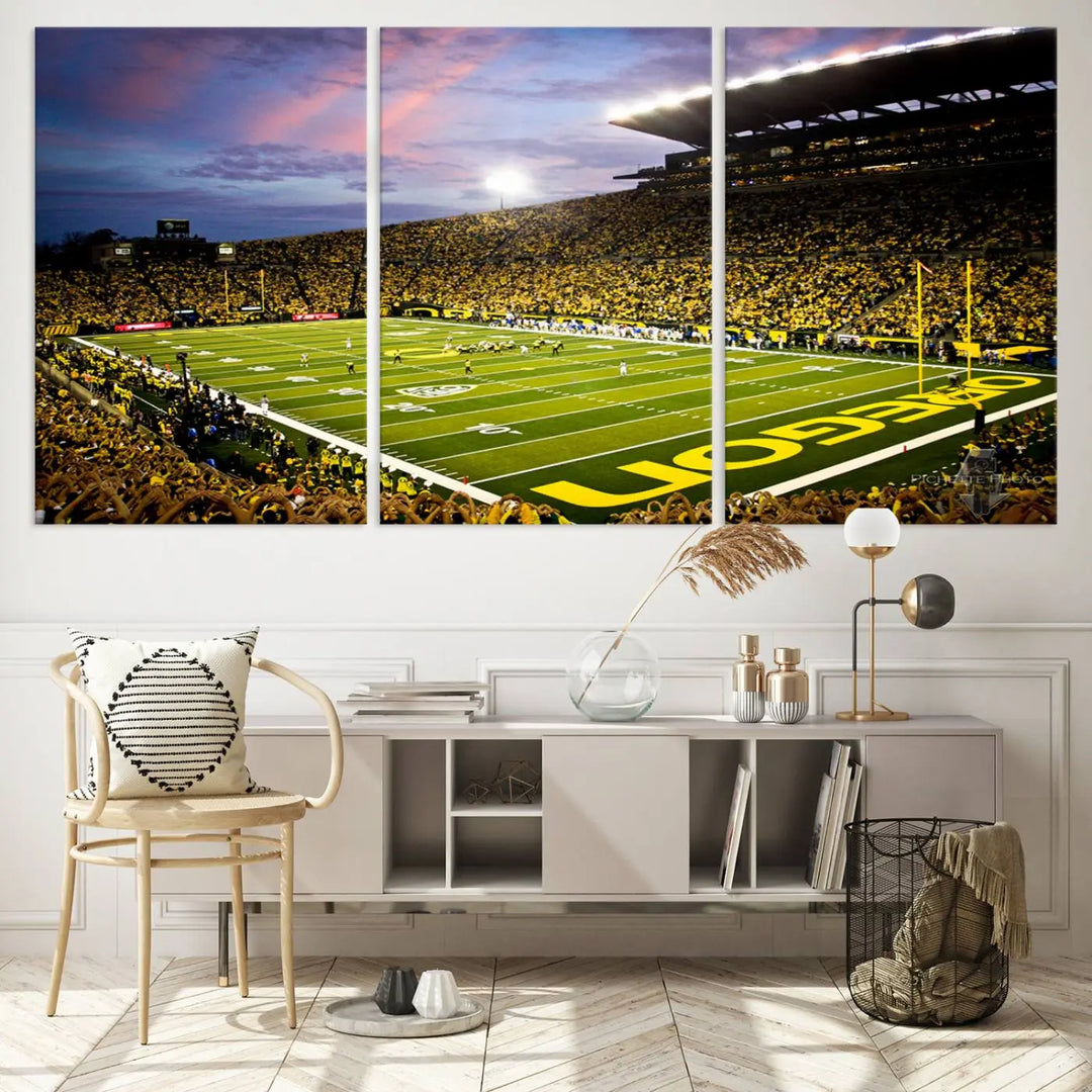 The living room showcases a triptych titled "University of Oregon Ducks Football Team Print - Eugene Autzen Stadium Wall Art Canvas Print," exhibiting a football stadium at sunset with a premium gallery-quality finish.