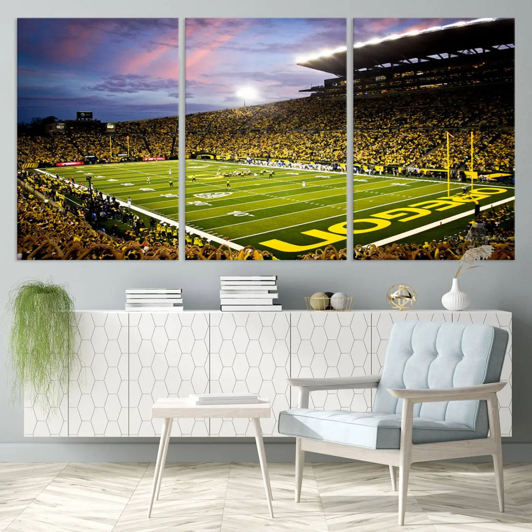 The living room showcases a triptych titled "University of Oregon Ducks Football Team Print - Eugene Autzen Stadium Wall Art Canvas Print," exhibiting a football stadium at sunset with a premium gallery-quality finish.