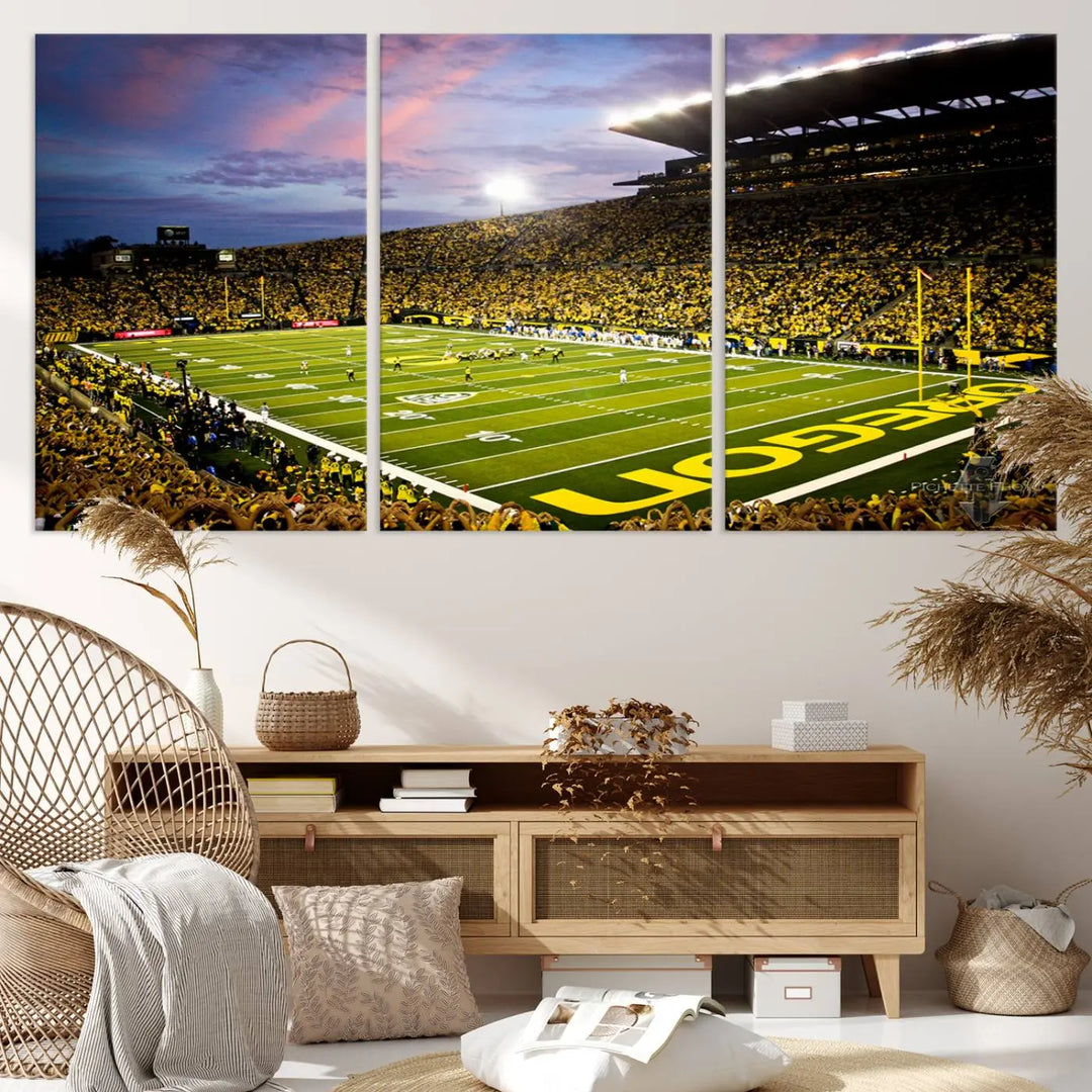 The living room showcases a triptych titled "University of Oregon Ducks Football Team Print - Eugene Autzen Stadium Wall Art Canvas Print," exhibiting a football stadium at sunset with a premium gallery-quality finish.