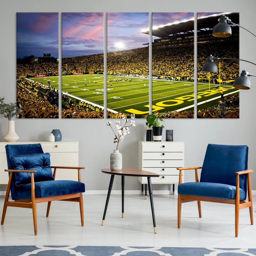 The living room showcases a triptych titled "University of Oregon Ducks Football Team Print - Eugene Autzen Stadium Wall Art Canvas Print," exhibiting a football stadium at sunset with a premium gallery-quality finish.