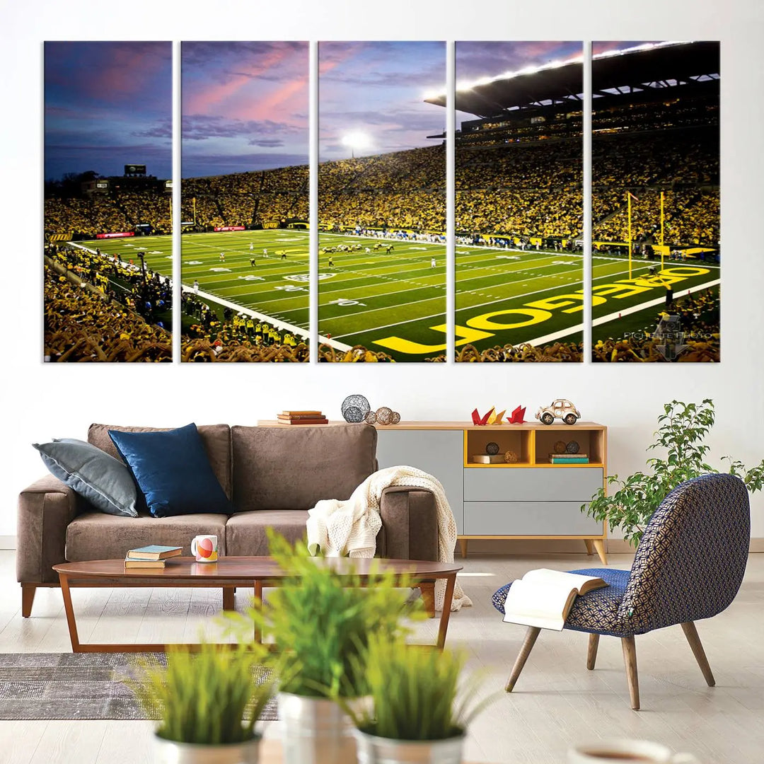 The living room showcases a triptych titled "University of Oregon Ducks Football Team Print - Eugene Autzen Stadium Wall Art Canvas Print," exhibiting a football stadium at sunset with a premium gallery-quality finish.