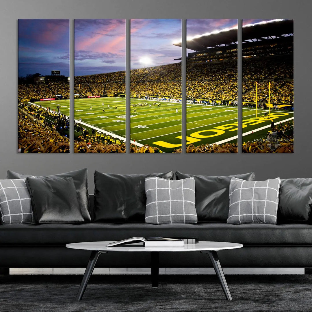 The living room showcases a triptych titled "University of Oregon Ducks Football Team Print - Eugene Autzen Stadium Wall Art Canvas Print," exhibiting a football stadium at sunset with a premium gallery-quality finish.