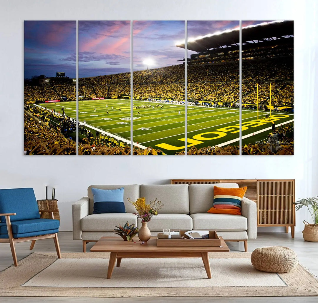 The living room showcases a triptych titled "University of Oregon Ducks Football Team Print - Eugene Autzen Stadium Wall Art Canvas Print," exhibiting a football stadium at sunset with a premium gallery-quality finish.