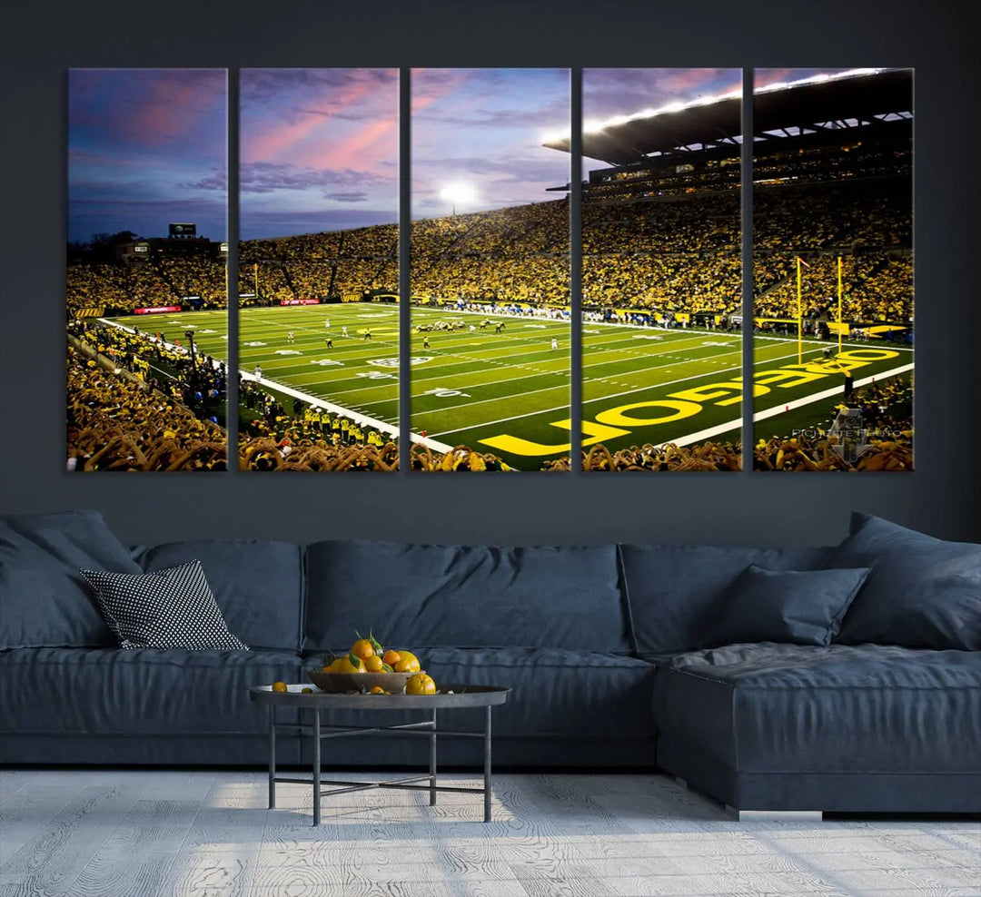 The living room showcases a triptych titled "University of Oregon Ducks Football Team Print - Eugene Autzen Stadium Wall Art Canvas Print," exhibiting a football stadium at sunset with a premium gallery-quality finish.