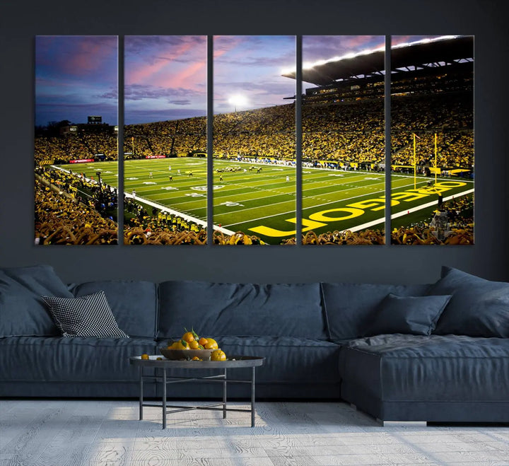 The living room showcases a triptych titled "University of Oregon Ducks Football Team Print - Eugene Autzen Stadium Wall Art Canvas Print," exhibiting a football stadium at sunset with a premium gallery-quality finish.