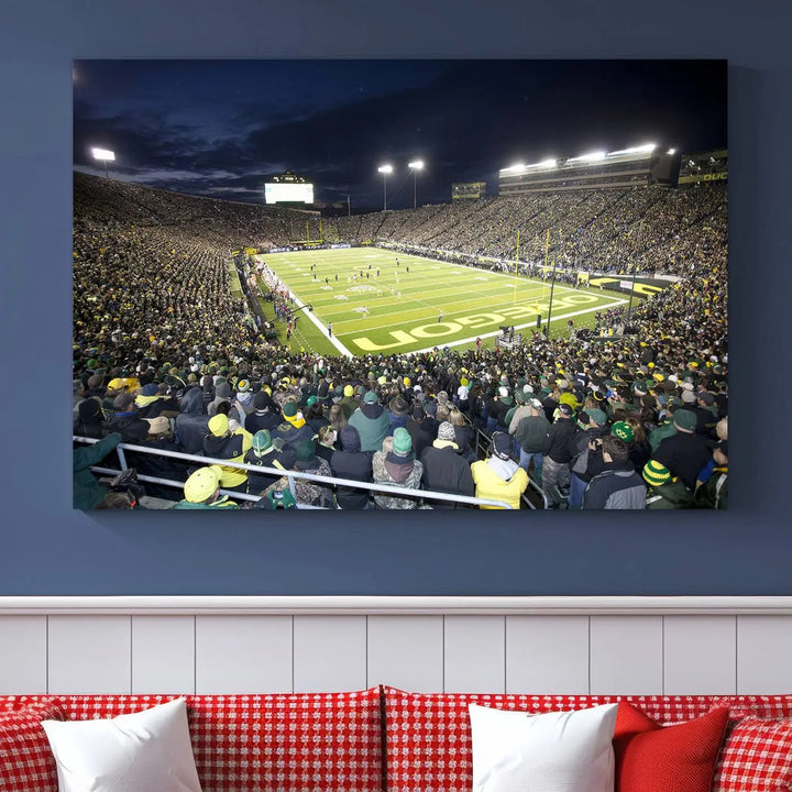 The living room features a triptych of wall art titled "University of Oregon Ducks Football Team Print - Eugene Autzen Stadium Wall Art Canvas Print," which depicts a bustling football stadium at night. Crafted on premium canvas and handmade in the USA, it serves as a striking focal point in the space.