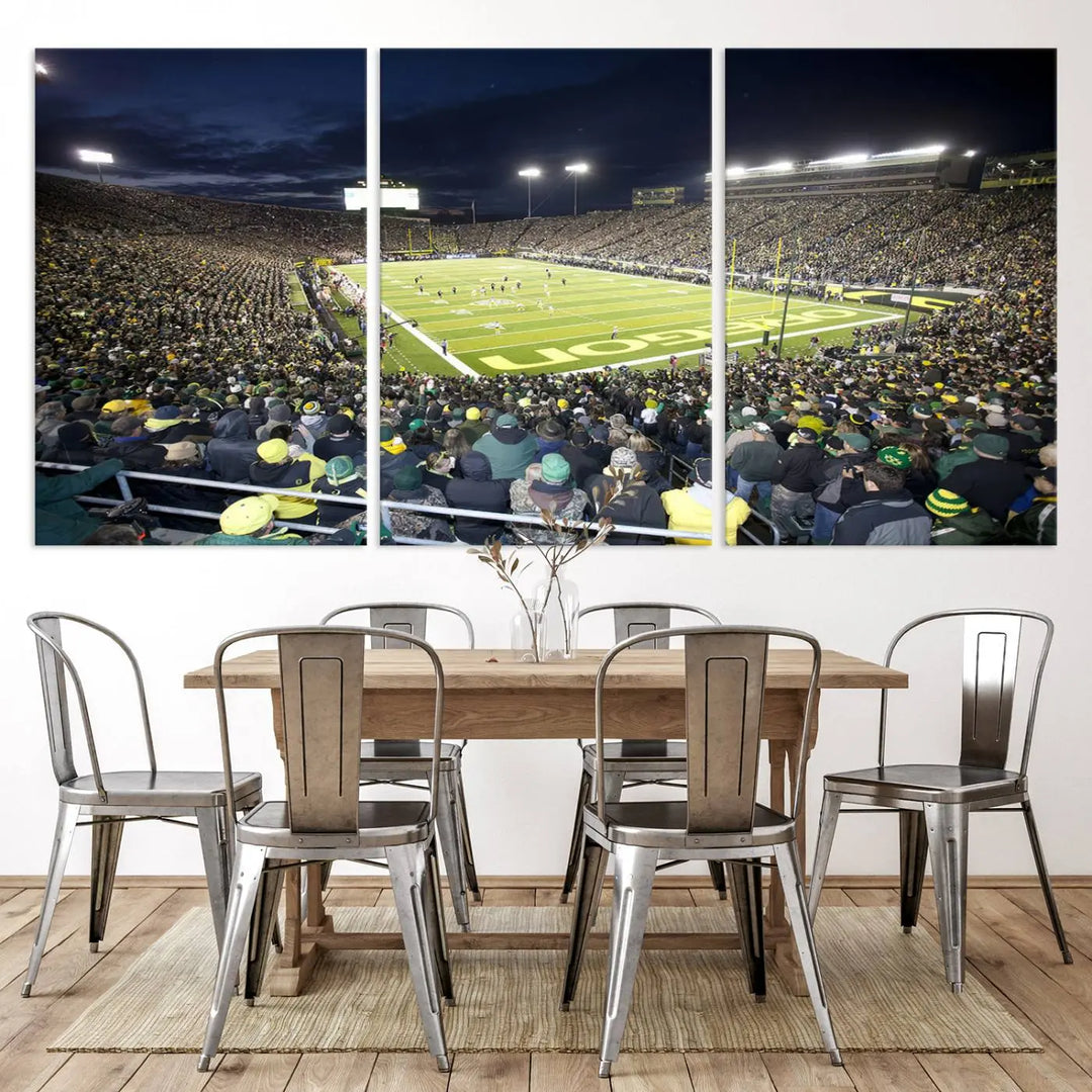 The living room features a triptych of wall art titled "University of Oregon Ducks Football Team Print - Eugene Autzen Stadium Wall Art Canvas Print," which depicts a bustling football stadium at night. Crafted on premium canvas and handmade in the USA, it serves as a striking focal point in the space.