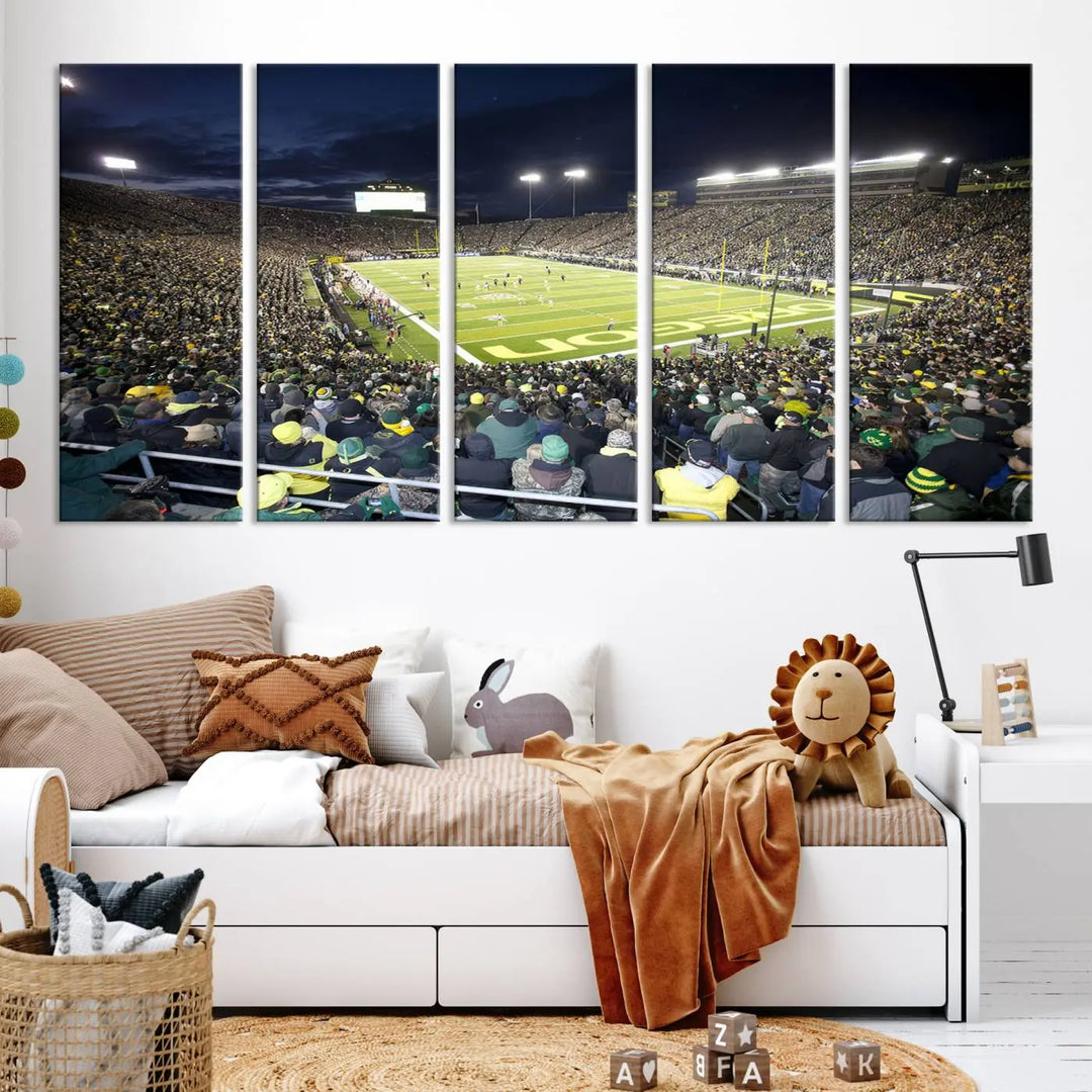 The living room features a triptych of wall art titled "University of Oregon Ducks Football Team Print - Eugene Autzen Stadium Wall Art Canvas Print," which depicts a bustling football stadium at night. Crafted on premium canvas and handmade in the USA, it serves as a striking focal point in the space.