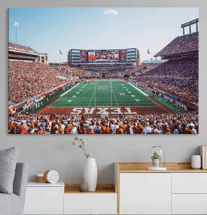 A University of Texas Longhorns Football Team Print, depicting the bustling Darrell K Royal-Texas Memorial Stadium at Campbell-Williams Field, is mounted in a modern living room.