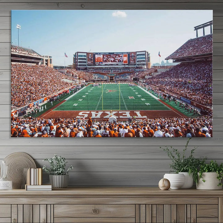 A University of Texas Longhorns Football Team Print, depicting the bustling Darrell K Royal-Texas Memorial Stadium at Campbell-Williams Field, is mounted in a modern living room.