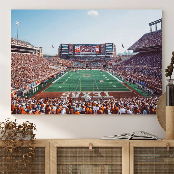 A University of Texas Longhorns Football Team Print, depicting the bustling Darrell K Royal-Texas Memorial Stadium at Campbell-Williams Field, is mounted in a modern living room.