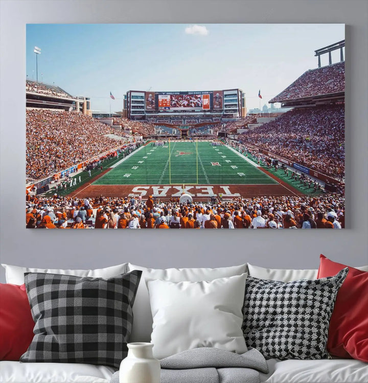 A University of Texas Longhorns Football Team Print, depicting the bustling Darrell K Royal-Texas Memorial Stadium at Campbell-Williams Field, is mounted in a modern living room.