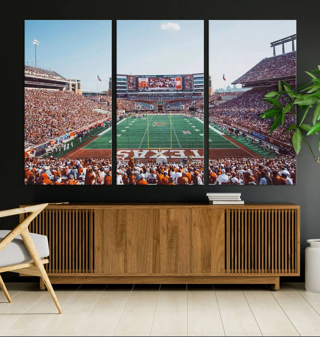 A University of Texas Longhorns Football Team Print, depicting the bustling Darrell K Royal-Texas Memorial Stadium at Campbell-Williams Field, is mounted in a modern living room.