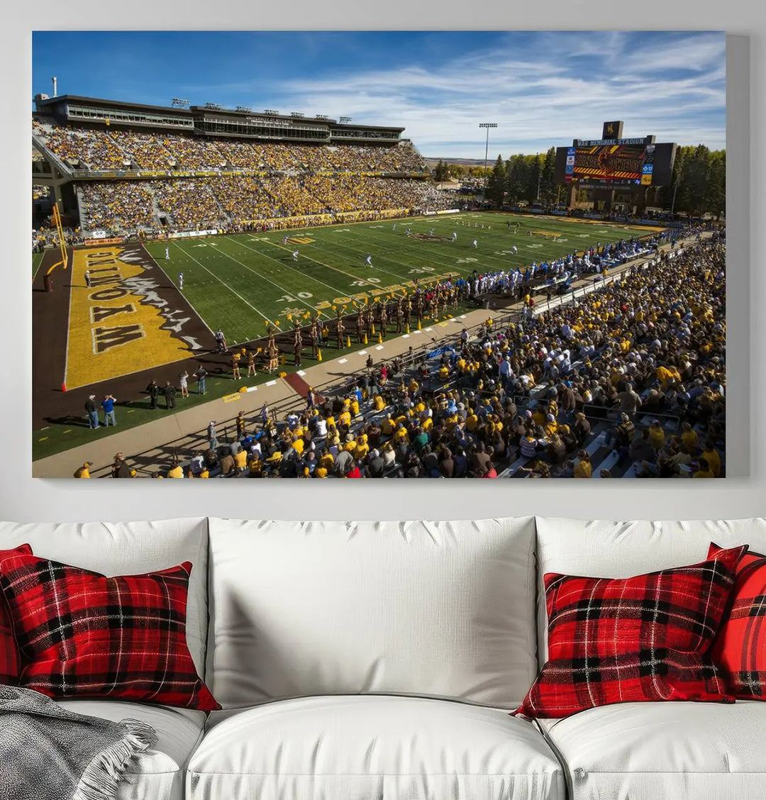 A premium canvas triptych, handmade in the USA, features the University of Wyoming Cowboys Football Team at Laramie Jonah Field as striking wall art on a beige wall.