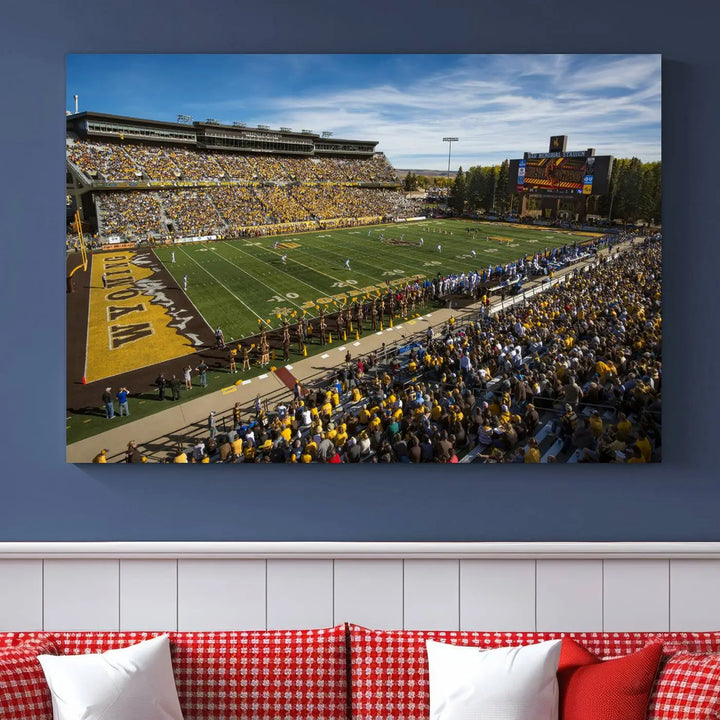 A premium canvas triptych, handmade in the USA, features the University of Wyoming Cowboys Football Team at Laramie Jonah Field as striking wall art on a beige wall.