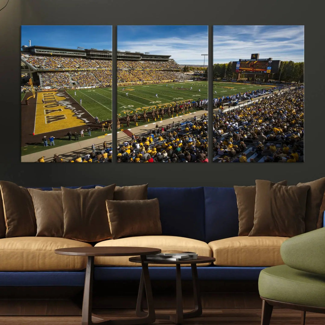 A premium canvas triptych, handmade in the USA, features the University of Wyoming Cowboys Football Team at Laramie Jonah Field as striking wall art on a beige wall.