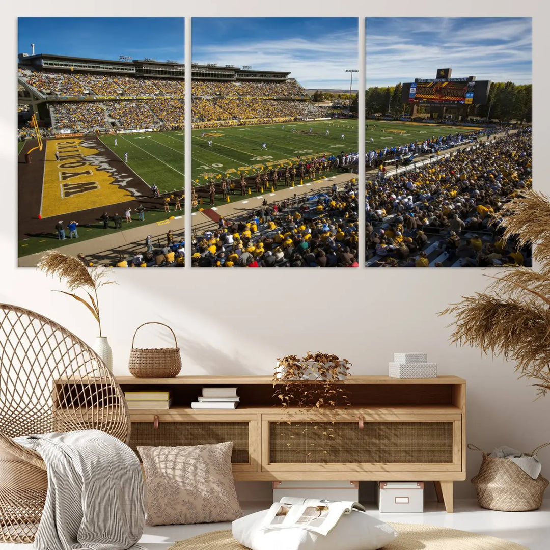 A premium canvas triptych, handmade in the USA, features the University of Wyoming Cowboys Football Team at Laramie Jonah Field as striking wall art on a beige wall.