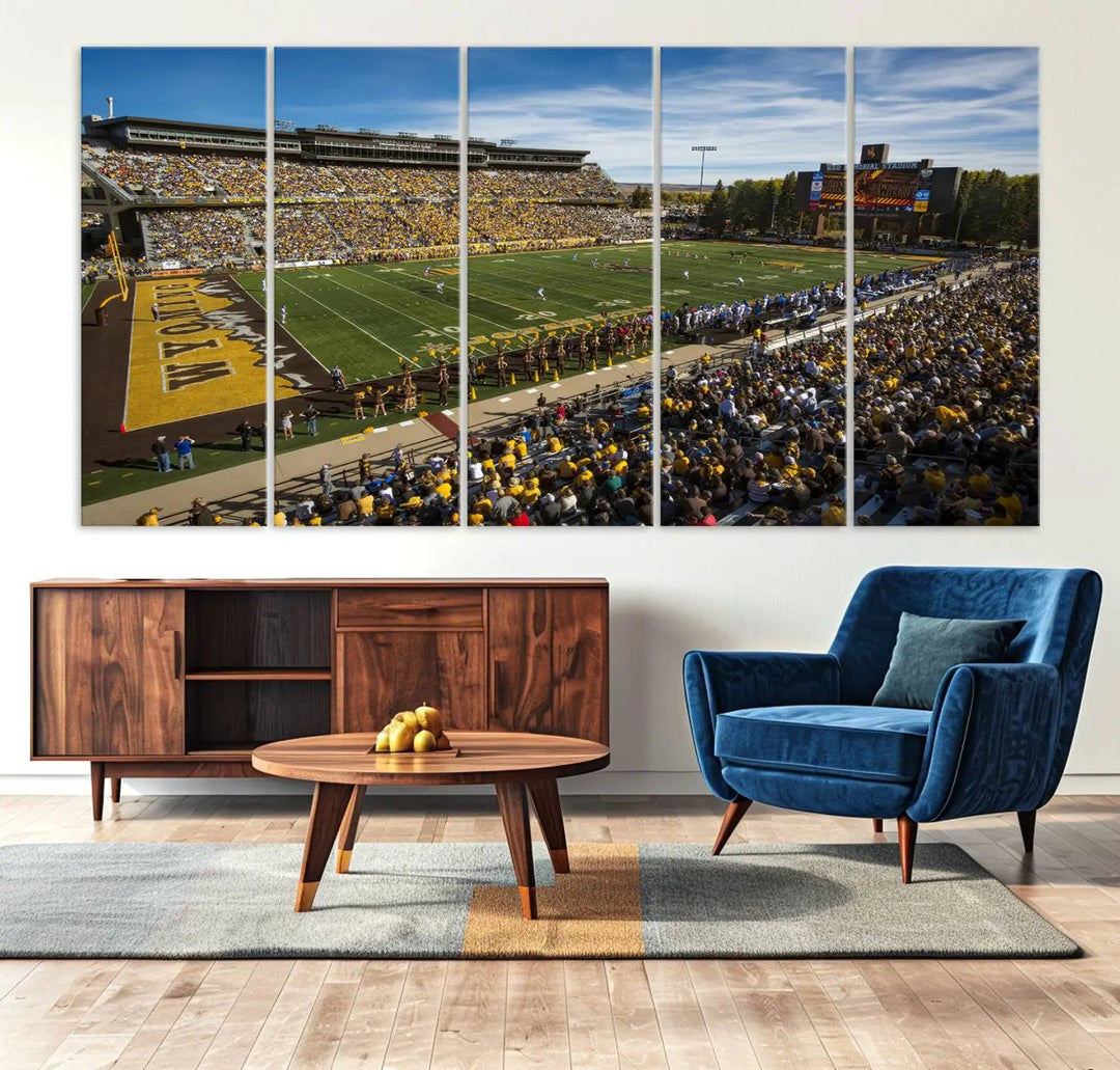 A premium canvas triptych, handmade in the USA, features the University of Wyoming Cowboys Football Team at Laramie Jonah Field as striking wall art on a beige wall.