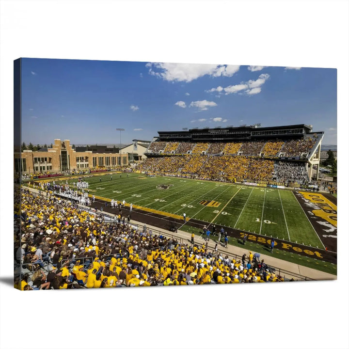 A University of Wyoming Cowboys Football Team print, featuring Laramie Jonah Field at War Memorial Stadium on a premium canvas, is displayed in the room.