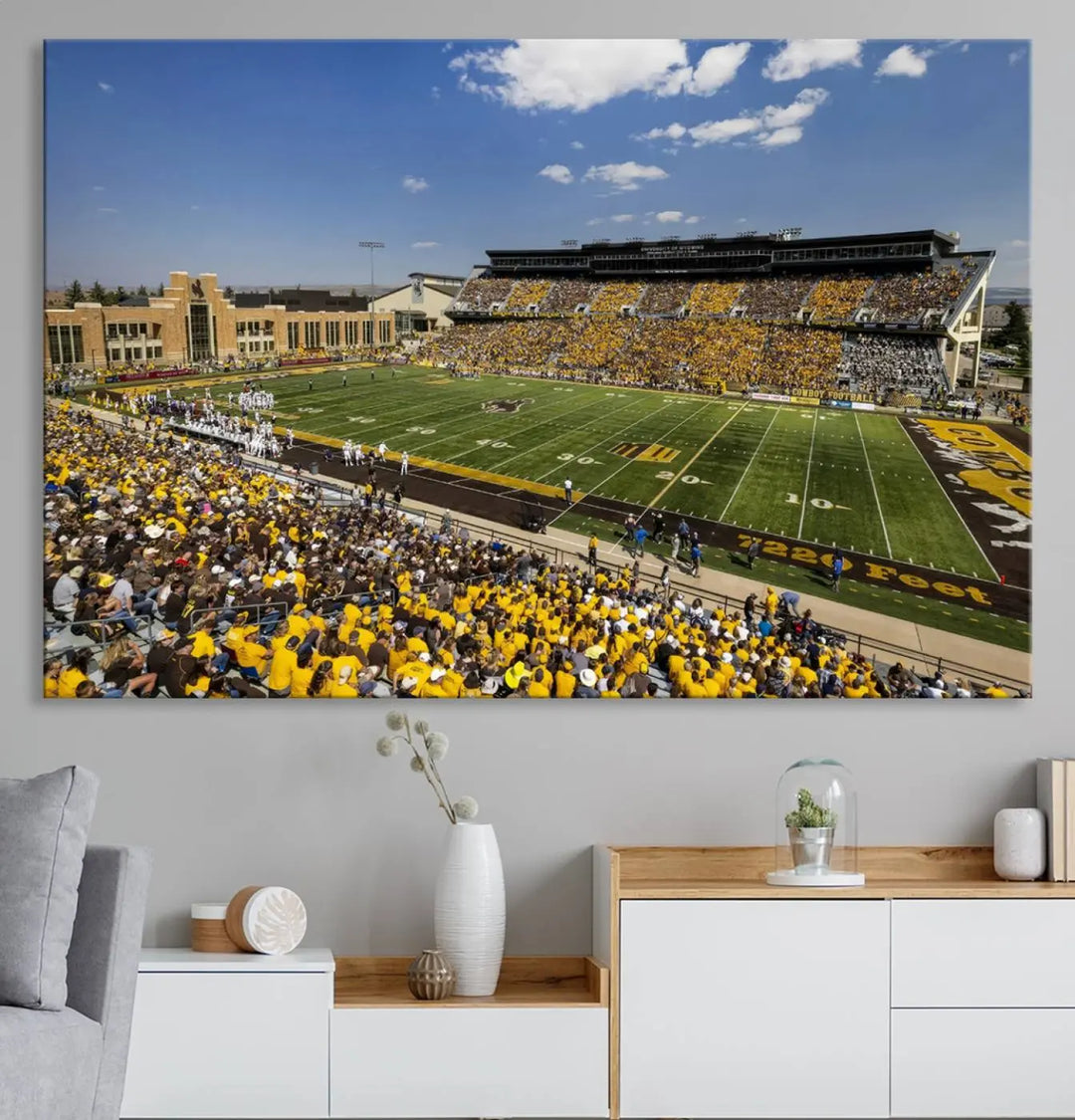 A University of Wyoming Cowboys Football Team print, featuring Laramie Jonah Field at War Memorial Stadium on a premium canvas, is displayed in the room.