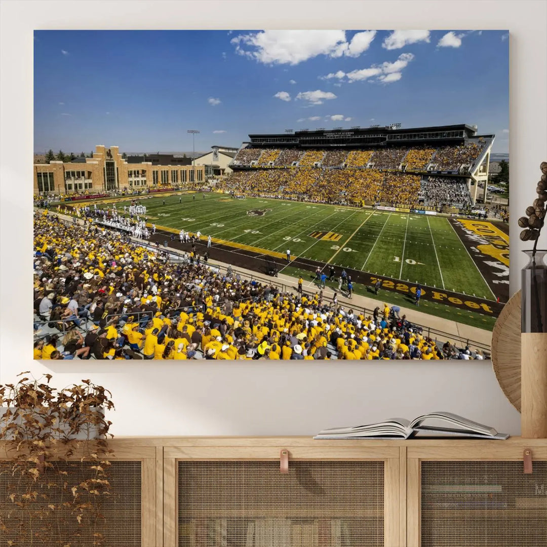 A University of Wyoming Cowboys Football Team print, featuring Laramie Jonah Field at War Memorial Stadium on a premium canvas, is displayed in the room.