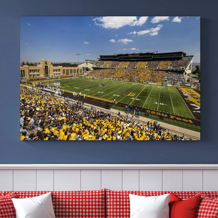 A University of Wyoming Cowboys Football Team print, featuring Laramie Jonah Field at War Memorial Stadium on a premium canvas, is displayed in the room.