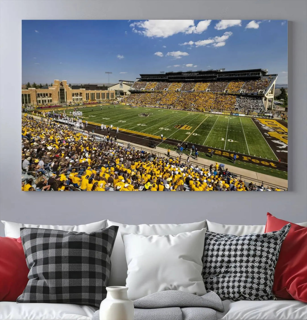 A University of Wyoming Cowboys Football Team print, featuring Laramie Jonah Field at War Memorial Stadium on a premium canvas, is displayed in the room.