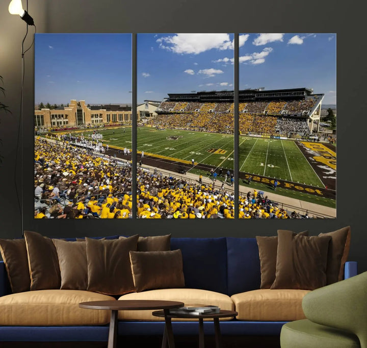 A University of Wyoming Cowboys Football Team print, featuring Laramie Jonah Field at War Memorial Stadium on a premium canvas, is displayed in the room.