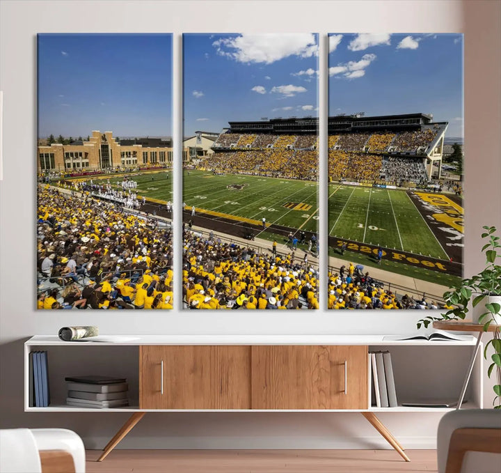 A University of Wyoming Cowboys Football Team print, featuring Laramie Jonah Field at War Memorial Stadium on a premium canvas, is displayed in the room.