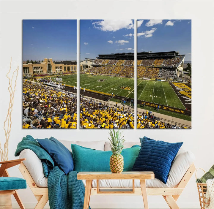 A University of Wyoming Cowboys Football Team print, featuring Laramie Jonah Field at War Memorial Stadium on a premium canvas, is displayed in the room.