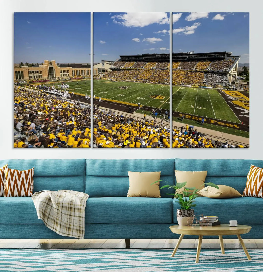 A University of Wyoming Cowboys Football Team print, featuring Laramie Jonah Field at War Memorial Stadium on a premium canvas, is displayed in the room.