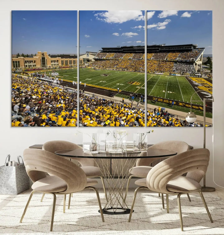 A University of Wyoming Cowboys Football Team print, featuring Laramie Jonah Field at War Memorial Stadium on a premium canvas, is displayed in the room.