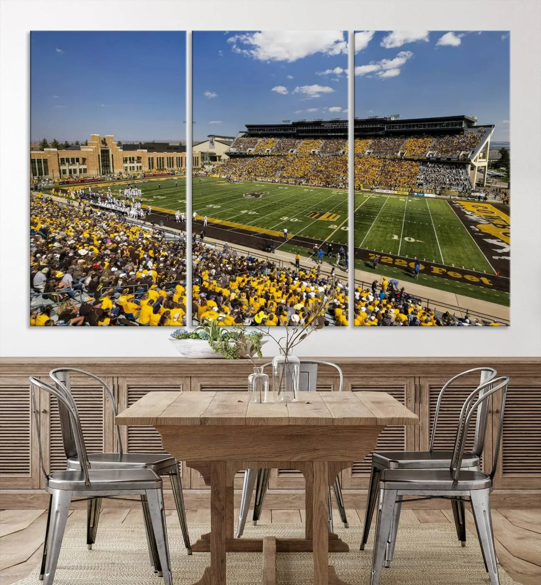 A University of Wyoming Cowboys Football Team print, featuring Laramie Jonah Field at War Memorial Stadium on a premium canvas, is displayed in the room.