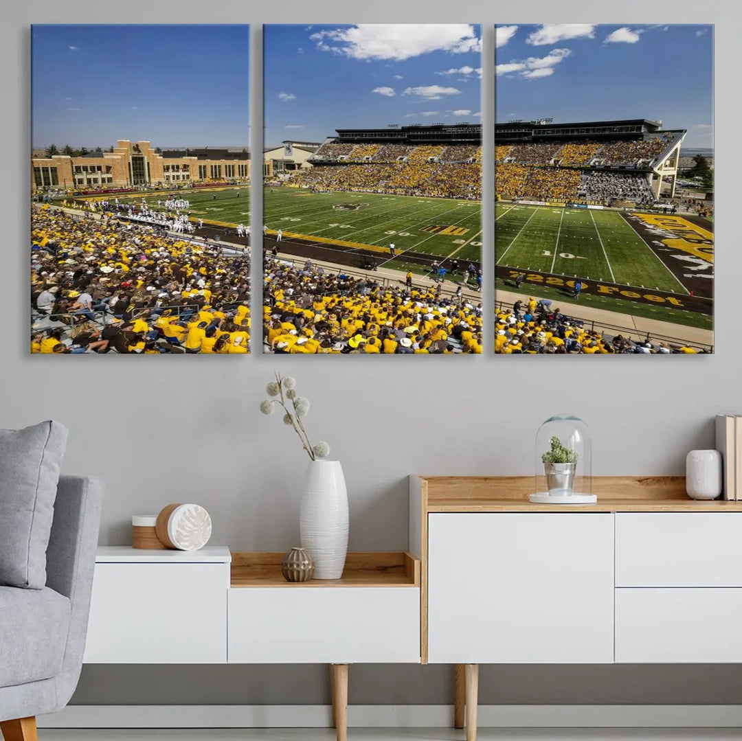 A University of Wyoming Cowboys Football Team print, featuring Laramie Jonah Field at War Memorial Stadium on a premium canvas, is displayed in the room.