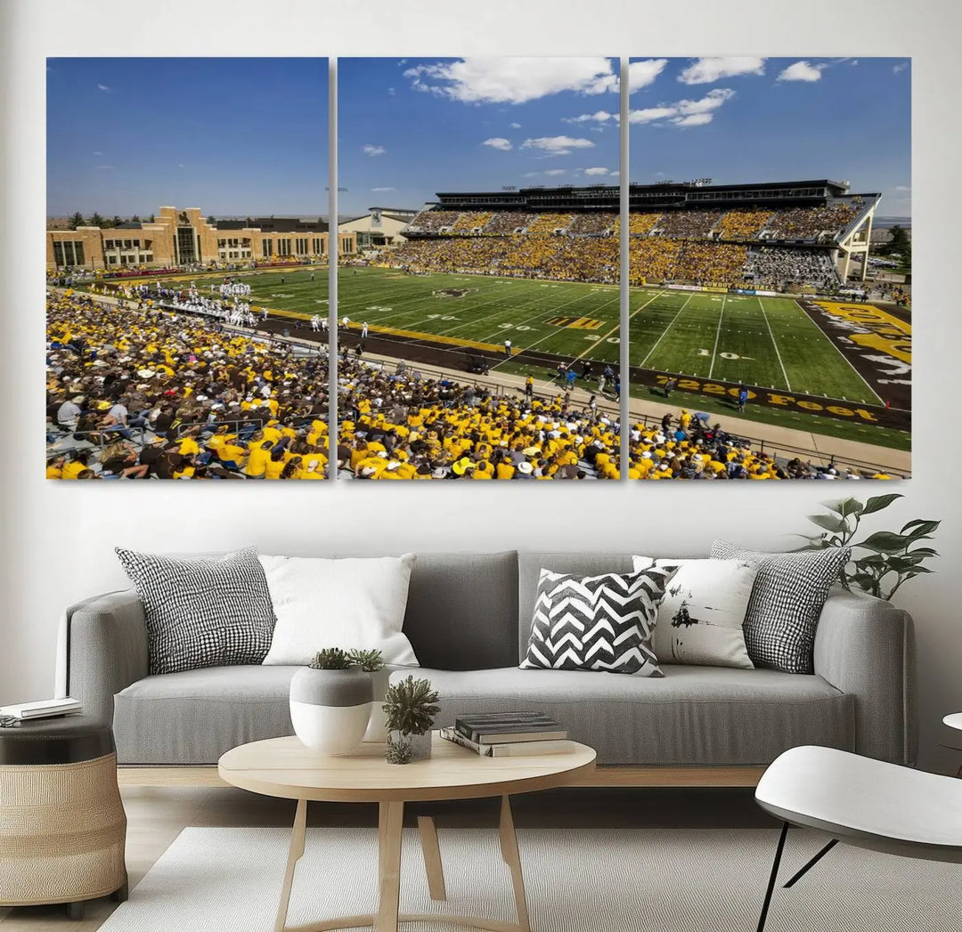 A University of Wyoming Cowboys Football Team print, featuring Laramie Jonah Field at War Memorial Stadium on a premium canvas, is displayed in the room.