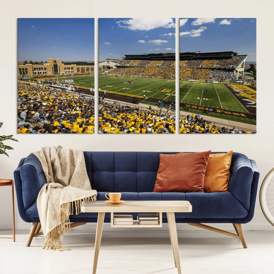 A University of Wyoming Cowboys Football Team print, featuring Laramie Jonah Field at War Memorial Stadium on a premium canvas, is displayed in the room.