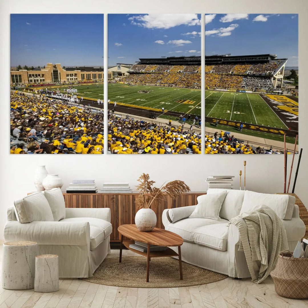 A University of Wyoming Cowboys Football Team print, featuring Laramie Jonah Field at War Memorial Stadium on a premium canvas, is displayed in the room.