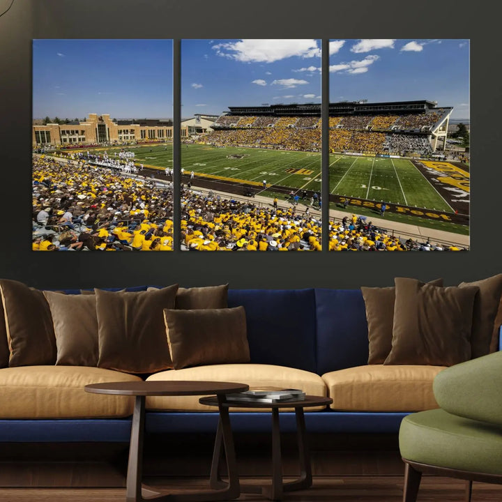 A University of Wyoming Cowboys Football Team print, featuring Laramie Jonah Field at War Memorial Stadium on a premium canvas, is displayed in the room.