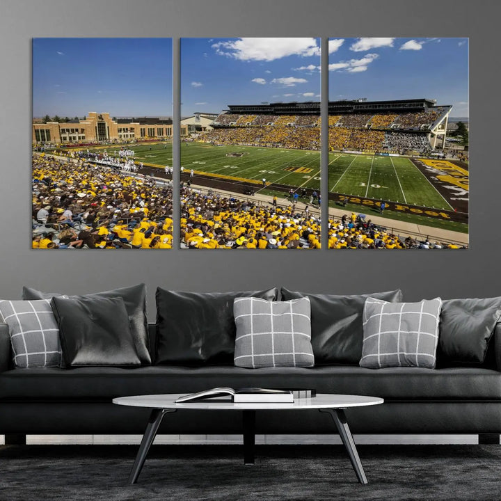 A University of Wyoming Cowboys Football Team print, featuring Laramie Jonah Field at War Memorial Stadium on a premium canvas, is displayed in the room.