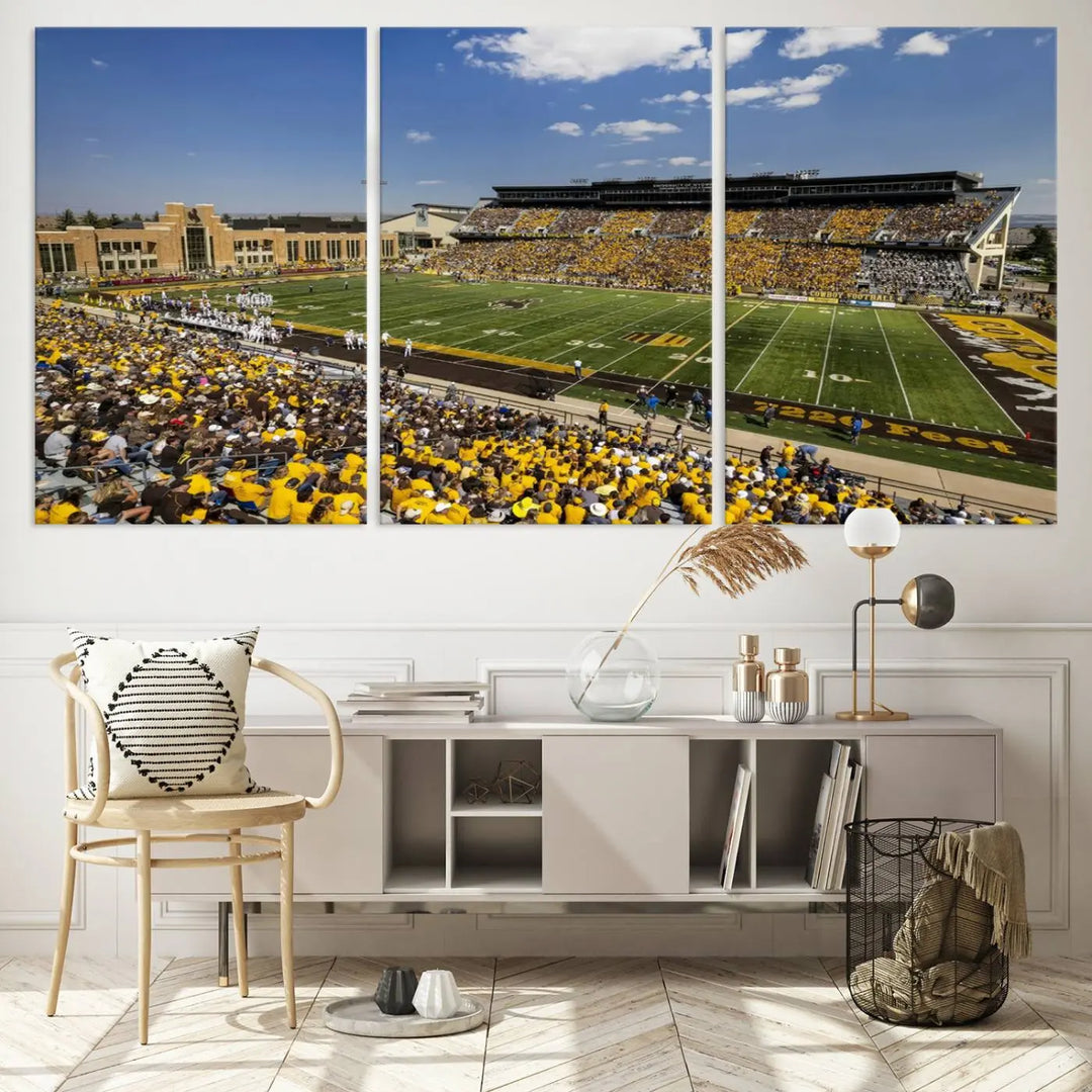 A University of Wyoming Cowboys Football Team print, featuring Laramie Jonah Field at War Memorial Stadium on a premium canvas, is displayed in the room.