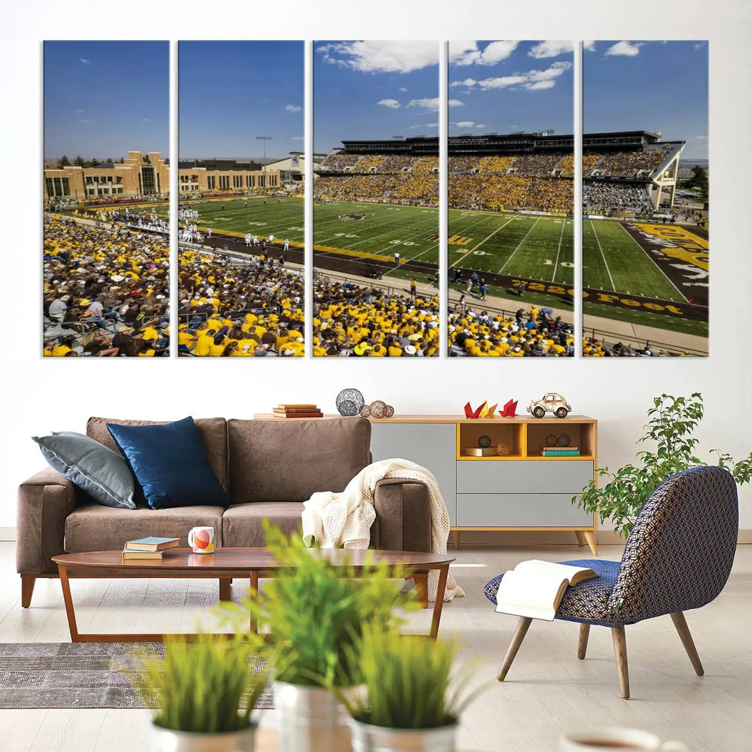 A University of Wyoming Cowboys Football Team print, featuring Laramie Jonah Field at War Memorial Stadium on a premium canvas, is displayed in the room.