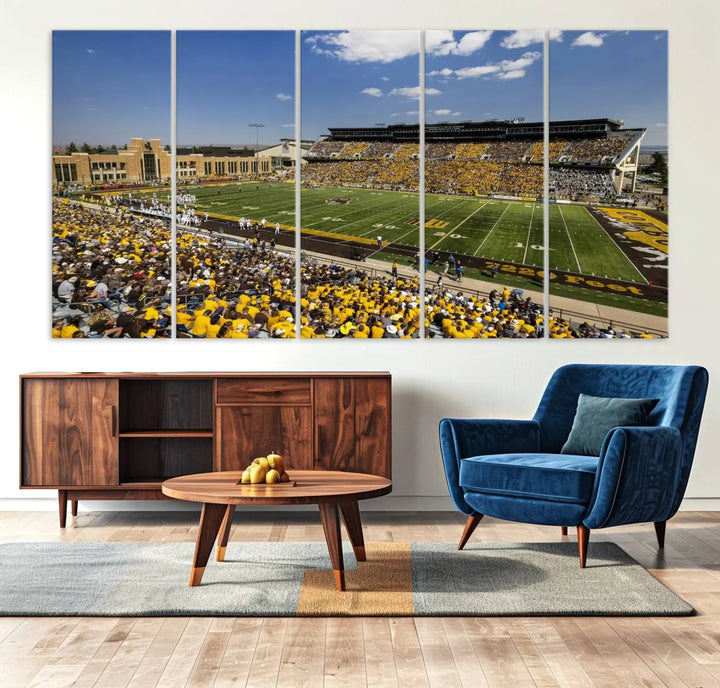 A University of Wyoming Cowboys Football Team print, featuring Laramie Jonah Field at War Memorial Stadium on a premium canvas, is displayed in the room.