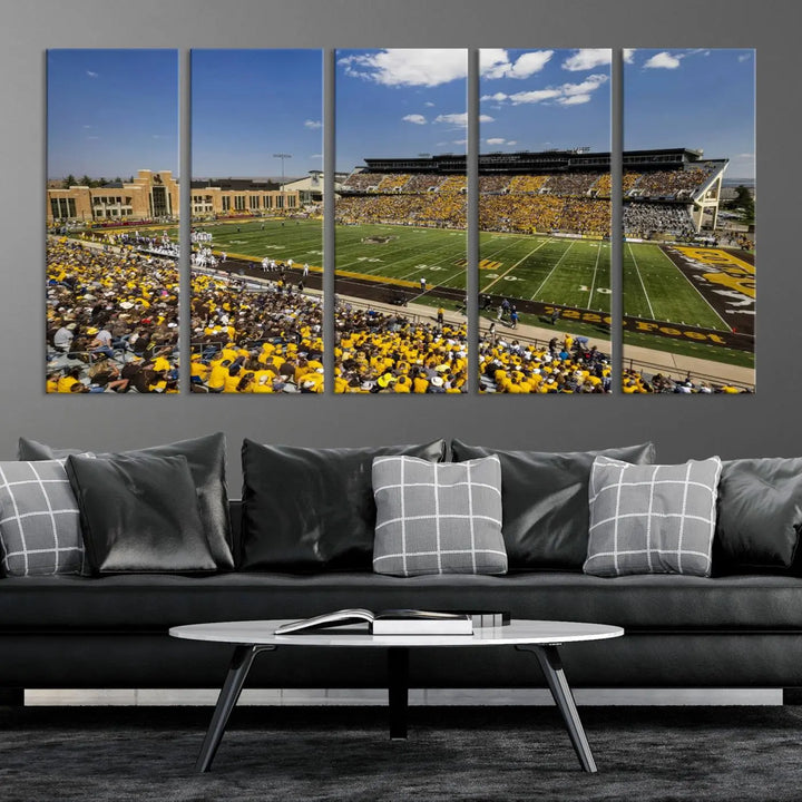 A University of Wyoming Cowboys Football Team print, featuring Laramie Jonah Field at War Memorial Stadium on a premium canvas, is displayed in the room.