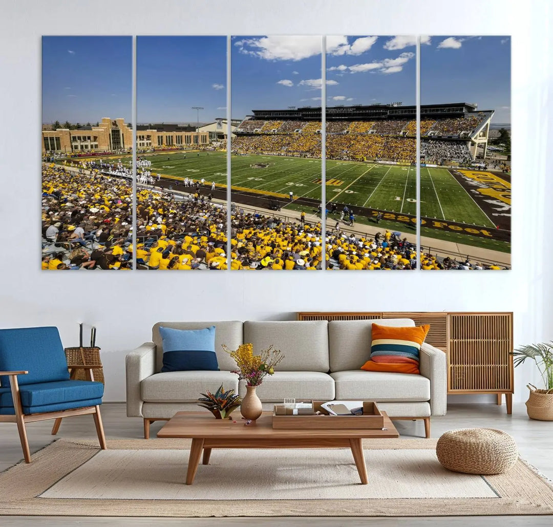 A University of Wyoming Cowboys Football Team print, featuring Laramie Jonah Field at War Memorial Stadium on a premium canvas, is displayed in the room.