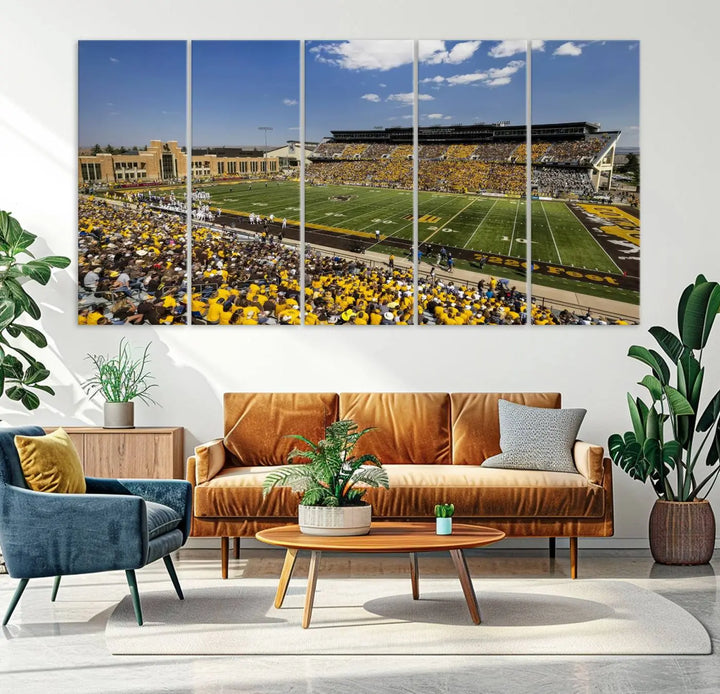 A University of Wyoming Cowboys Football Team print, featuring Laramie Jonah Field at War Memorial Stadium on a premium canvas, is displayed in the room.