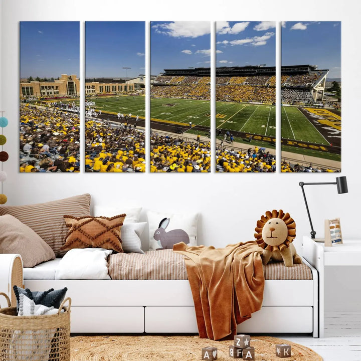 A University of Wyoming Cowboys Football Team print, featuring Laramie Jonah Field at War Memorial Stadium on a premium canvas, is displayed in the room.