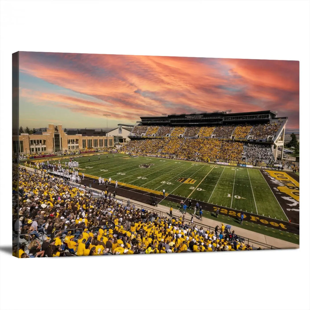 A living room wall showcases a stunning handmade canvas artwork featuring the lively University of Wyoming Cowboys football team at Jonah Field in War Memorial Stadium, beautifully set under a vibrant sunset sky.